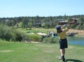 Young golfer hitting a nice tee shot