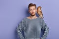 Young good looking man holds a predatory tamed owl on his shoulder Royalty Free Stock Photo