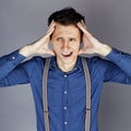 Young goofy man with pimples pointing in studio