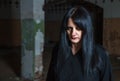 Young goth woman in an abandoned building