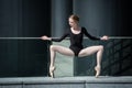 Young graceful ballerina in black bathing suit on