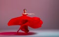 A young graceful ballerina, dressed in pointe shoes and a weightless red skirt, demonstrates her dancing skills. The beauty of Royalty Free Stock Photo