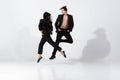 Young and graceful ballet dancers in minimal black style isolated on white studio background