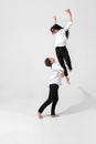 Young and graceful ballet dancers in minimal black style isolated on white studio background