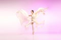 Ballerina. Young graceful female ballet dancer dancing over pink studio. Beauty of classic ballet. Royalty Free Stock Photo