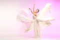 Ballerina. Young graceful female ballet dancer dancing over pink studio. Beauty of classic ballet. Royalty Free Stock Photo