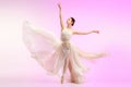 Ballerina. Young graceful female ballet dancer dancing over pink studio. Beauty of classic ballet. Royalty Free Stock Photo