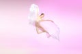 Ballerina. Young graceful female ballet dancer dancing over pink studio. Beauty of classic ballet. Royalty Free Stock Photo