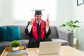 Young graduate attending his online virtual ceremony Royalty Free Stock Photo