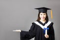 young graduate holding diploma with showing gesture Royalty Free Stock Photo