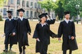 young graduated students in capes walking