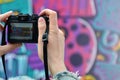 A young graffiti artist photographs his completed picture on the wall Royalty Free Stock Photo