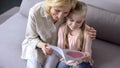 Young grandchild showing handmade greeting card to granny, mothers day, close up