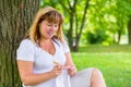 Young grandmother in the park crochet