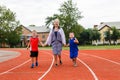 Young grandmother runs a sports stadium with the grandkids