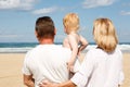 Young grandparents with a grandchild in her arms