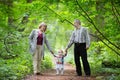 Young grandparents walking with their baby granddaughter