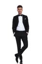 Young groom in black tuxedo standing with hands in pockets Royalty Free Stock Photo