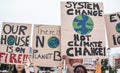 Young group of demonstrators on road from different culture and race fight for climate change - Focus on banners