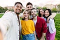 Young group of diverse college friends taking selfie standing together outdoors Royalty Free Stock Photo