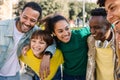 Young group of diverse friends laughing together at city street. Royalty Free Stock Photo