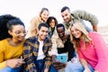 Young group of diverse friends looking at mobile phone screen Royalty Free Stock Photo