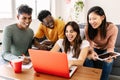 Young group of diverse students studying together using laptop at home Royalty Free Stock Photo