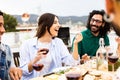 Young group of friends having barbecue dinner party at terrace rooftop in summer Royalty Free Stock Photo