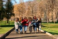 Young group of girls walking in autumn park autumn clothes and autumn walk. Graduation from high school