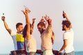 Young group having fun on the beach and dancing in a convertible car Royalty Free Stock Photo