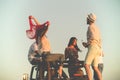 Young group having fun on the beach and dancing in a convertible car Royalty Free Stock Photo