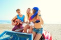 Young group having fun on beach playing guitar Royalty Free Stock Photo