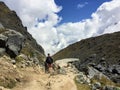 A young group of international hikers, led by their local Inca guide, navigate the Andes mountains Royalty Free Stock Photo