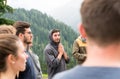 Group of young people standing in a circle and praying together Royalty Free Stock Photo