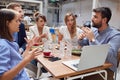 Young group of people discussing about content on laptop at lunch in restaurant. business meeting in restaurant Royalty Free Stock Photo