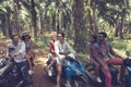 Young Group Of People Driving Scooters Travel In Tropical Forest Cheerful Friends Having Road Trip On Bikes