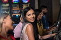 Young Group Playing Automat Machine in a Casino Royalty Free Stock Photo