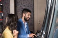 Young Group Playing Automat Machine in a Casino Royalty Free Stock Photo