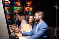 Young Group Playing Automat Machine in a Casino Royalty Free Stock Photo