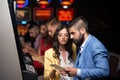 Young Group Playing Automat Machine in a Casino Royalty Free Stock Photo