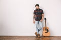 Young guitarist hipster at home with guitar standing Royalty Free Stock Photo