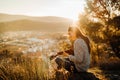 Young guitarist playing acoustic guitar and enoying the sunset.Learning to play an instrument.Singer-songwriter in nature Royalty Free Stock Photo