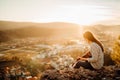 Young guitarist playing acoustic guitar and enoying the sunset.Learning to play an instrument.Singer-songwriter in nature Royalty Free Stock Photo