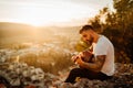Young guitarist playing acoustic guitar and looking to sunset.Searching inspiration.Music creator.New artist.Musical talent. Royalty Free Stock Photo