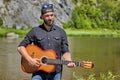 Young guitarist playing a guitar outdoors Royalty Free Stock Photo