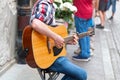 Young guitarist playing in the street Royalty Free Stock Photo