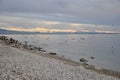 Sea landscape with sea gulls landing and flying over the beach