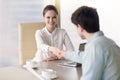 Young guy accepted for a job and female manager handshaking Royalty Free Stock Photo