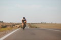 Young guy in activewear biking fast on paved road Royalty Free Stock Photo