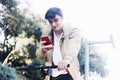 Young handsome guy on a bicycle looking at mobile phone